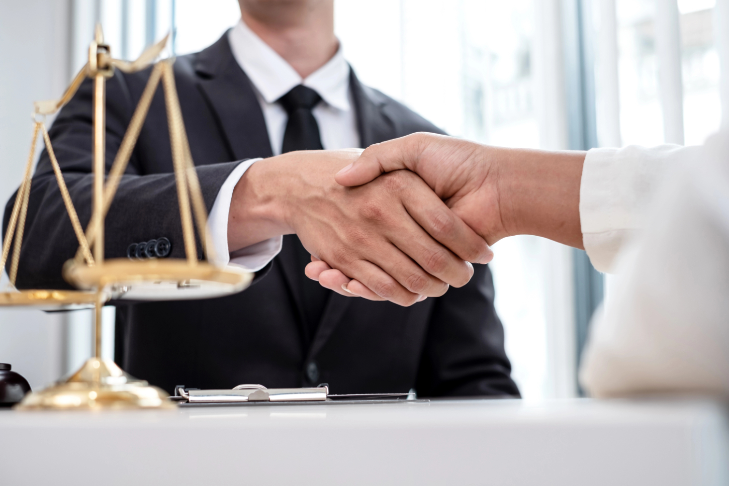 Shake hand professional male lawyers work at a law office Shake hand professional male lawyers work at a law office